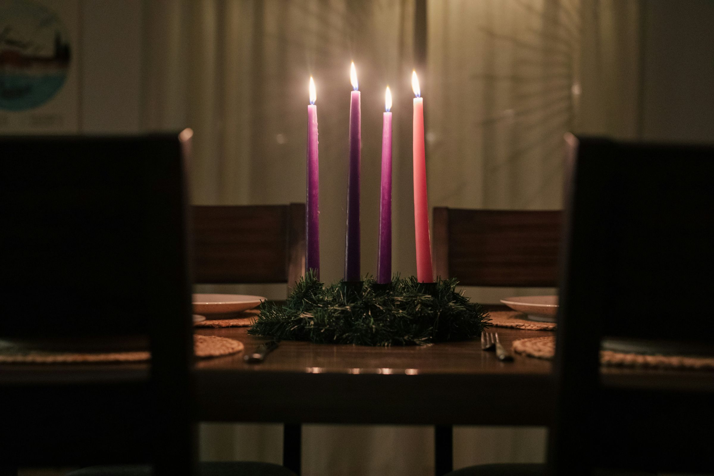 Lit Advent wreath on a dining room table