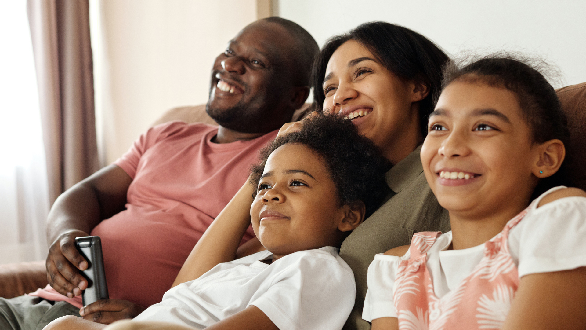 A happy family watching CatholicTV