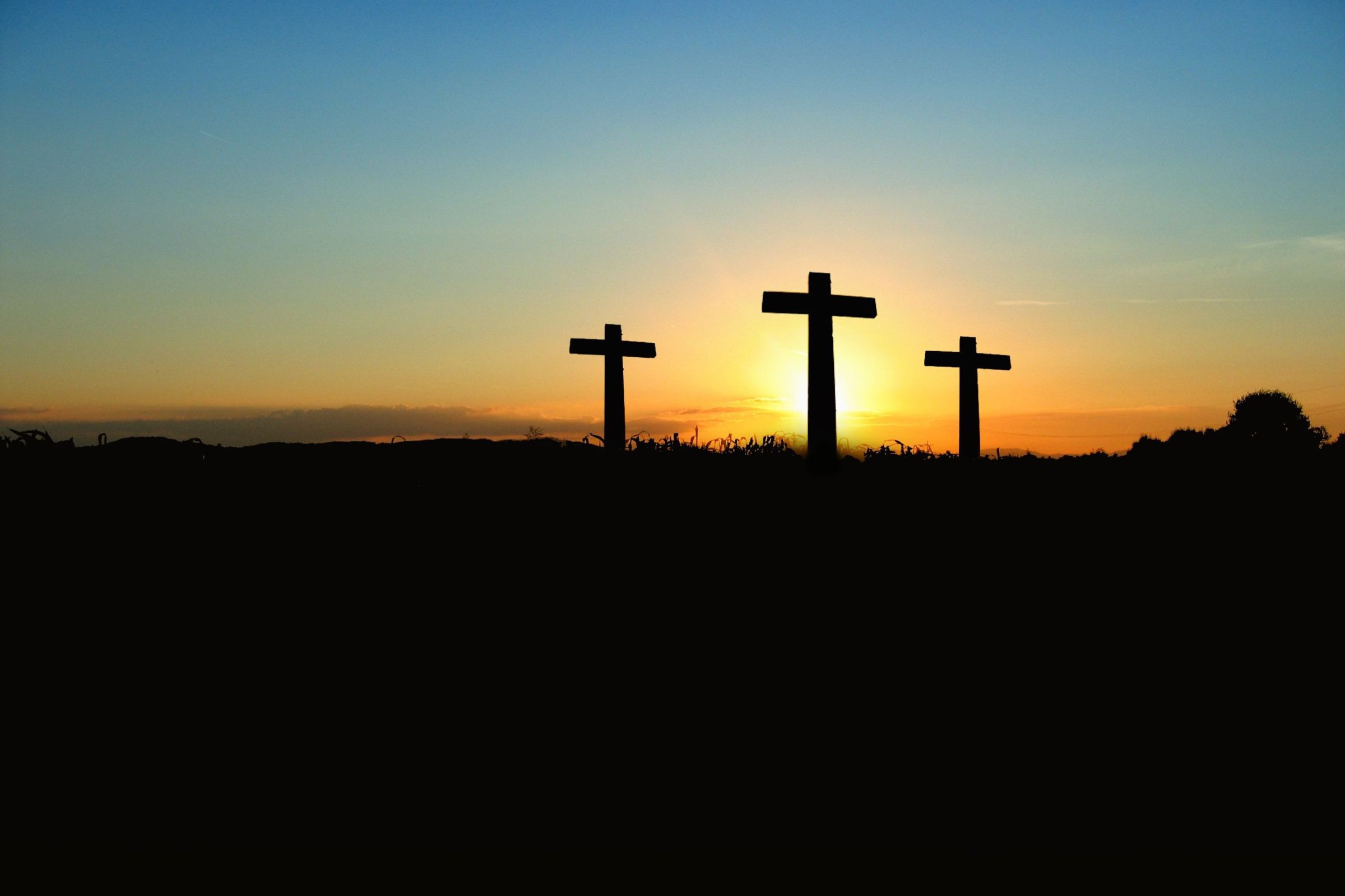 Sunrise with three crosses in the foreground