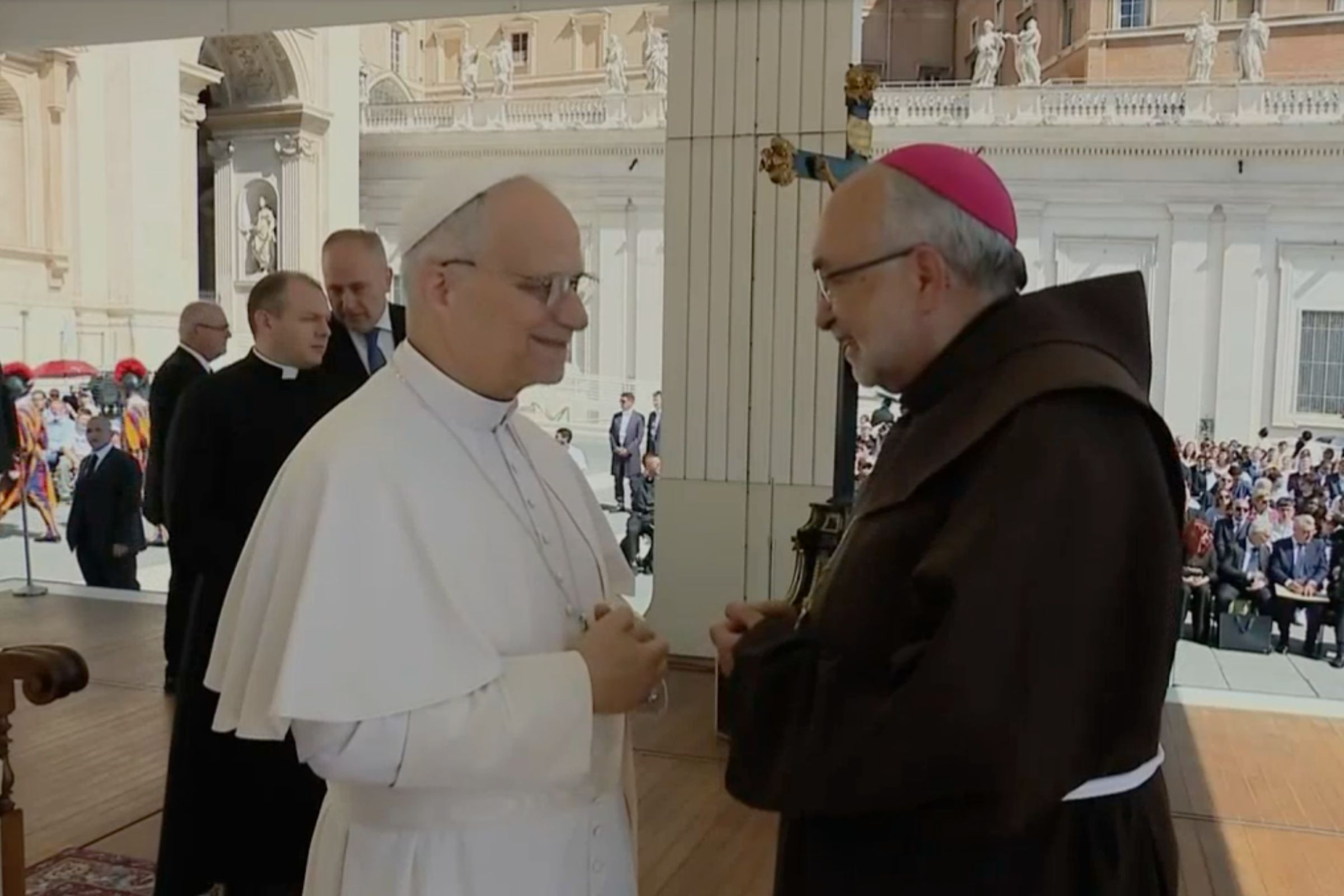 Pope Leo XIV greeting a clergyman at a weekly audience