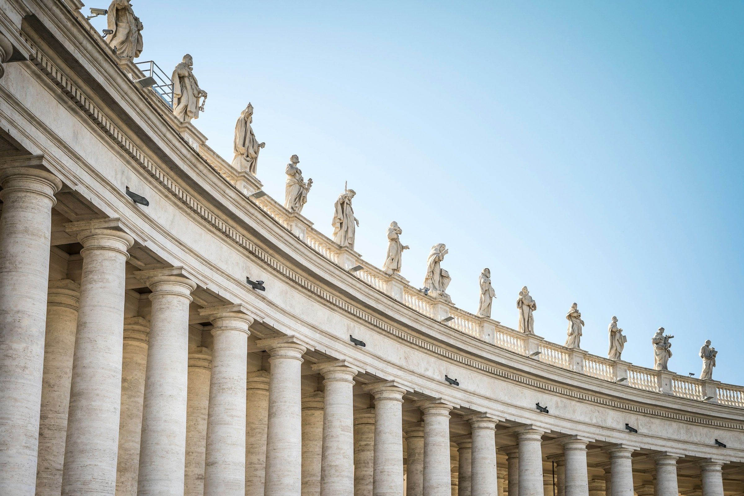 The statues on top of the pillars at St. Peter's Square